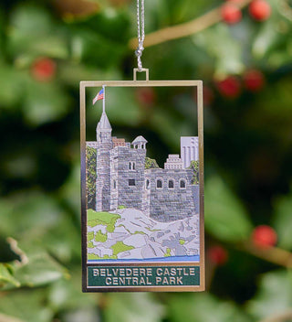 Elegant brass ornament featuring Belvedere Castle in Central Park, detailed with greenery and the American flag. All products available through Central Park Conservancy Shop.