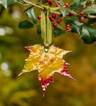 Golden maple leaf ornament with vibrant autumn colors, inspired by Central Park's iconic foliage. All products available through Central Park Conservancy Shop