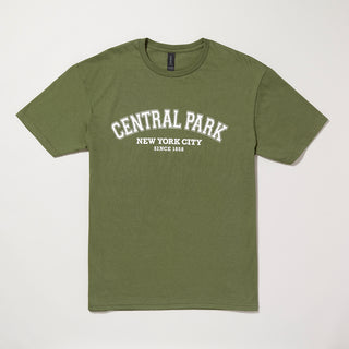 Green t-shirt with 'Central Park New York City Since 1858' text in white. Shirt is laying flat on a gray background