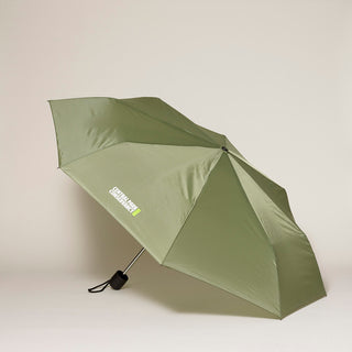 Soft olive green umbrella with Central Park Conservancy logo on a gray background  background