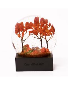 This snow globe features iridescent flakes reminiscent of falling leaves in Central Park. Each glass globe is packaged in a gift box with a protective foam insert. Measures 4" in diameter and the total measurements are 4x4x5".