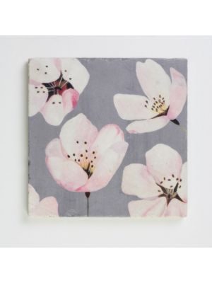 This cherry blossom trivet is made from strikingly elegant and notably durable Botticino Marble. Measures 6 square inches. Each piece is unique because of the natural variations of the marble and comes with a cork backing to protect furniture.