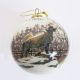 This globular glass ornament shows an image of the popular statue of Balto with 